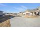 A street view of a suburban neighborhood showcasing well-maintained homes and driveways under a clear sky at 14434 W 88Th Dr # B, Arvada, CO 80005