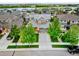 Aerial view of a residential neighborhood with a two-story home featuring a well-manicured lawn and mature trees at 4738 Colorado River Dr, Firestone, CO 80504
