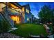 Backyard featuring a manicured lawn, garden, seating area, second story deck and walk out basement at 4738 Colorado River Dr, Firestone, CO 80504