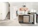 Entertaining bar area with a wet bar, custom sign, mini fridge, and easy access to the lower level at 4738 Colorado River Dr, Firestone, CO 80504