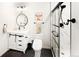 Modern bathroom featuring a glass-enclosed shower, sleek fixtures, and a vanity with a sliding barn door at 4738 Colorado River Dr, Firestone, CO 80504