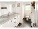 Bright bathroom with double granite vanity, decorative mirrors, and tile flooring near the tub and shower at 4738 Colorado River Dr, Firestone, CO 80504