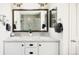 Modern bathroom featuring double sinks, granite countertop, and framed mirrors at 4738 Colorado River Dr, Firestone, CO 80504