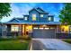 Charming two-story home with a two-car garage and well-maintained front yard and stone facade at 4738 Colorado River Dr, Firestone, CO 80504