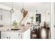 Open-concept kitchen view into dining area and white staircase at 4738 Colorado River Dr, Firestone, CO 80504