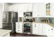 Bright, modern kitchen with stainless steel appliances and white cabinetry at 4738 Colorado River Dr, Firestone, CO 80504