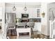 Modern kitchen with an island, stainless steel appliances, and glass cabinet displays at 4738 Colorado River Dr, Firestone, CO 80504