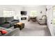 Spacious living room with a fireplace, large windows, a gaming table, and comfortable seating at 4738 Colorado River Dr, Firestone, CO 80504