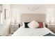 Bright main bedroom featuring a tufted headboard, side tables, and fresh interior design at 4738 Colorado River Dr, Firestone, CO 80504
