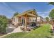 Covered backyard patio with outdoor dining, grill, and landscaped yard at 20058 E Dartmouth Dr, Aurora, CO 80013