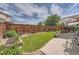 Spacious backyard with lush lawn, beautiful landscaping, and a covered patio at 20058 E Dartmouth Dr, Aurora, CO 80013