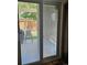View of the fenced backyard and patio with chair through the sliding glass door at 20058 E Dartmouth Dr, Aurora, CO 80013