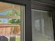 View of the fenced backyard and patio with furniture seen through window blinds at 20058 E Dartmouth Dr, Aurora, CO 80013