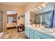Bright bathroom with dual sinks, tile floors, and glass-enclosed shower with access to main bedroom at 20058 E Dartmouth Dr, Aurora, CO 80013