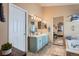 Bright bathroom featuring dual sinks, tile floors, large mirrors, and a bathtub at 20058 E Dartmouth Dr, Aurora, CO 80013