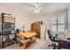 Bright bedroom with a ceiling fan, a wooden dresser, a desk and storage at 20058 E Dartmouth Dr, Aurora, CO 80013