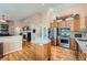 Modern kitchen featuring stainless steel appliances, an island, and hardwood floors at 20058 E Dartmouth Dr, Aurora, CO 80013