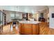 Spacious kitchen featuring granite countertops, an island, and hardwood floors at 20058 E Dartmouth Dr, Aurora, CO 80013