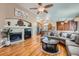 Inviting living room with a fireplace, hardwood floors, and a view to kitchen at 20058 E Dartmouth Dr, Aurora, CO 80013