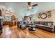 Open-concept living room with hardwood floors, ceiling fan and access to kitchen at 20058 E Dartmouth Dr, Aurora, CO 80013