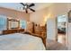 Bedroom featuring hardwood furniture, ceiling fan, and natural light from shuttered windows at 20058 E Dartmouth Dr, Aurora, CO 80013
