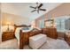 Comfortable main bedroom featuring wood furniture, soft lighting, and shuttered windows at 20058 E Dartmouth Dr, Aurora, CO 80013