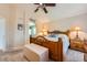 Spacious main bedroom with wood furniture, soft lighting, and ensuite bathroom at 20058 E Dartmouth Dr, Aurora, CO 80013