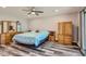 Cozy main bedroom featuring a ceiling fan, wood-look floors, and ample natural light at 16521 E 121St Cir Dr, Brighton, CO 80603