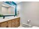 Double vanity bathroom with modern fixtures and teal accent wall at 9593 Coronado Ct, Parker, CO 80134