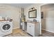 Convenient laundry room with washer, dryer, and a vanity sink at 9593 Coronado Ct, Parker, CO 80134