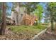 View of the home's backyard with a wooden deck, stairs, lush lawn, and mature trees at 20740 Parker Vista Rd, Parker, CO 80138