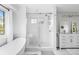 Bright bathroom with a modern glass shower, soaking tub, and double vanity at 20740 Parker Vista Rd, Parker, CO 80138