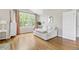 Bright bedroom sitting area featuring hardwood floors and large window with view at 20740 Parker Vista Rd, Parker, CO 80138