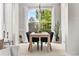 Bright dining room with a modern chandelier, large window, and a stylish table setting for elegant meals at 20740 Parker Vista Rd, Parker, CO 80138