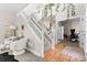 Inviting entryway with a grand staircase, stylish decor, and a glimpse into a home office or study at 20740 Parker Vista Rd, Parker, CO 80138