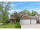 Well-maintained home with a spacious three-car garage, manicured lawn, and inviting curb appeal at 20740 Parker Vista Rd, Parker, CO 80138