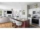 Open concept view of the kitchen island that features seating, a stainless steel oven, and a view of the living area at 20740 Parker Vista Rd, Parker, CO 80138