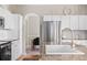 Well-lit kitchen with white cabinets, a large stainless steel refrigerator, and an island at 20740 Parker Vista Rd, Parker, CO 80138