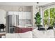 Bright kitchen with stainless steel appliances, a granite-topped island, and a large window at 20740 Parker Vista Rd, Parker, CO 80138