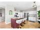 Bright kitchen with a large island, white cabinets, and stainless steel appliances at 20740 Parker Vista Rd, Parker, CO 80138