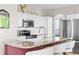 Kitchen island with seating, stainless steel appliances, and modern fixtures at 20740 Parker Vista Rd, Parker, CO 80138