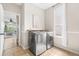 Modern laundry room featuring stainless steel washer and dryer and natural light from window at 20740 Parker Vista Rd, Parker, CO 80138