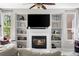 Cozy living room features a fireplace, built-in shelving, and ample natural light at 20740 Parker Vista Rd, Parker, CO 80138