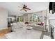Bright, open living room with a large sectional sofa, a fireplace and open access to the kitchen at 20740 Parker Vista Rd, Parker, CO 80138