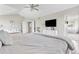 Bright main bedroom features hardwood floors and large bed with access to ensuite bathroom at 20740 Parker Vista Rd, Parker, CO 80138