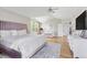 Bright main bedroom featuring hardwood floors, vaulted ceilings, and large windows with natural light at 20740 Parker Vista Rd, Parker, CO 80138