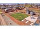 Aerial view of a well-maintained backyard featuring a sand pit, garden boxes and patio at 5000 W Dakota Ave, Denver, CO 80219