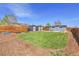 Backyard featuring a green lawn, storage sheds, garden boxes, and a modern horizontal fence at 5000 W Dakota Ave, Denver, CO 80219