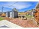 Backyard brick patio featuring grill and two sheds at 5000 W Dakota Ave, Denver, CO 80219