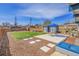 Large backyard featuring patio, grass, and two sheds at 5000 W Dakota Ave, Denver, CO 80219